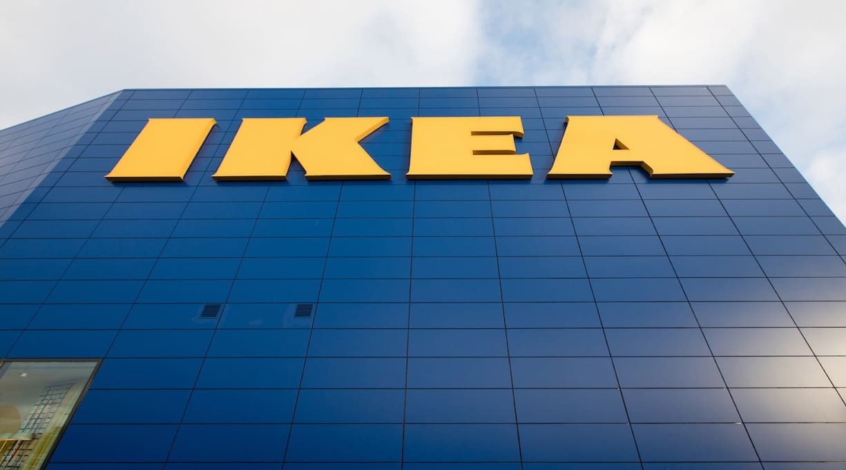IKEA logo on towering IKEA building with sky visible behind