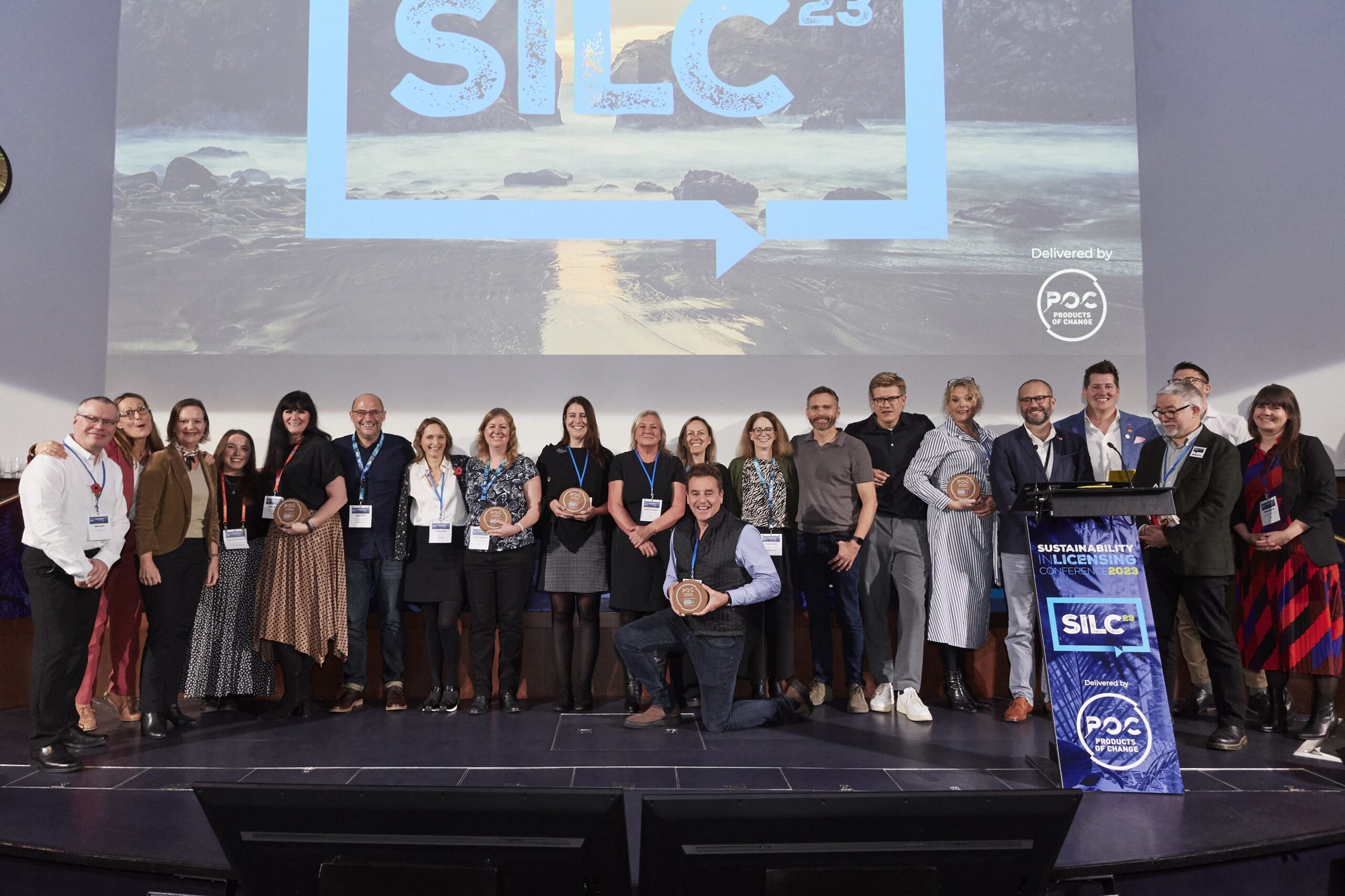 Products of Change team members on stage at a sustainability conference, actively engaging in industry-leading dialogue and collaboration.