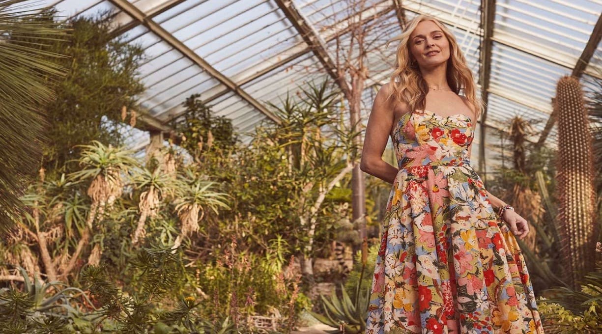 Fearne Cotton stood in a greenhouse surrounded by plants while she wears a dress from the Nobody's Child collection