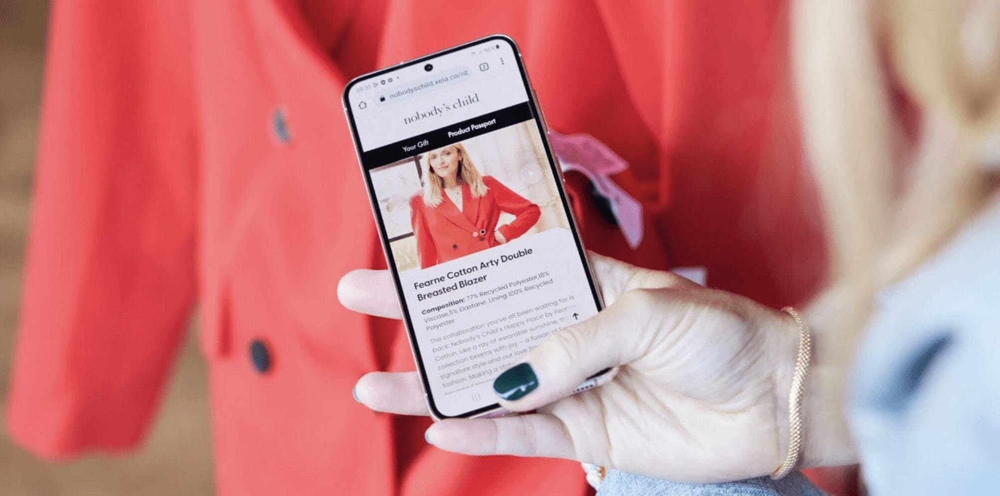 hand holding a phone scanning an item of clothing to bring up[ information on the phone screen