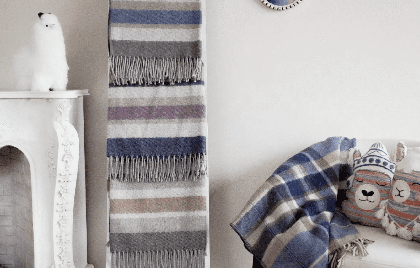 A bedroom setting featuring Peruvian made merino woollen items