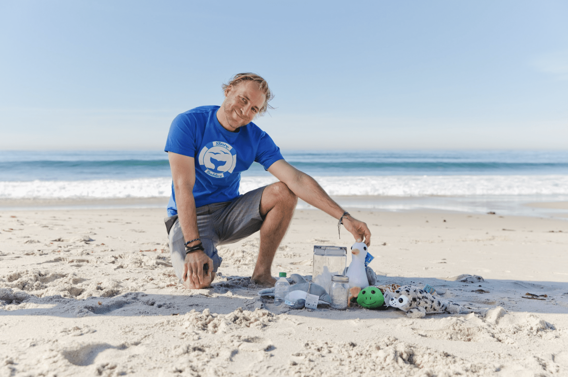 Malte Niebleschuetz poses for a beach photo with his collection of Shore Buddies