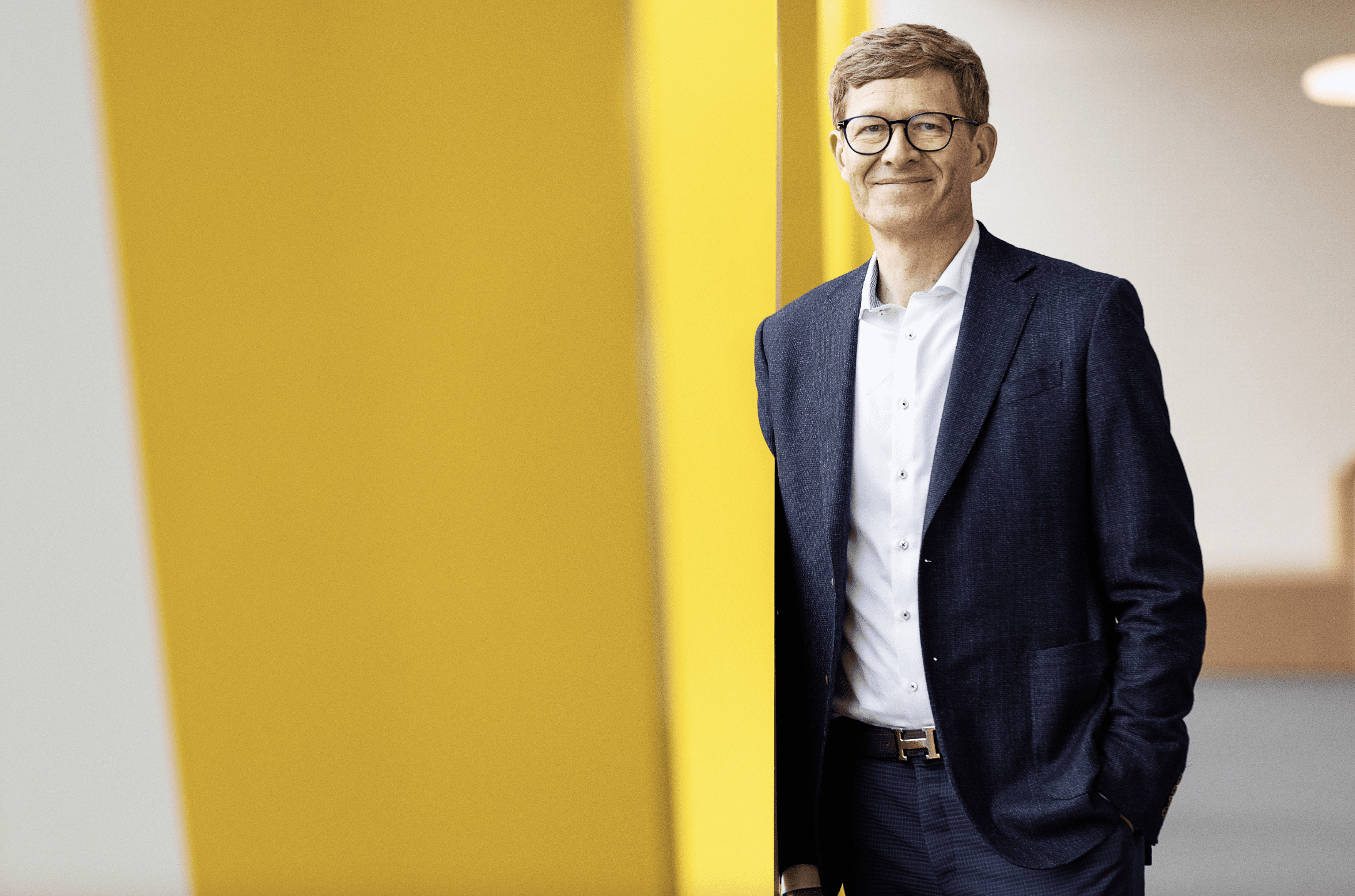 LEGO ceo, Niels B Christiansen stands against a yellow and white backdrop