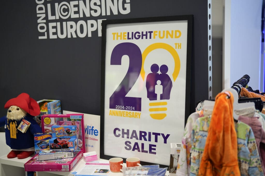 A selection of the products on sale for the Light Fund sale on the POC booth, including children's toys and a rail of children's clothes.