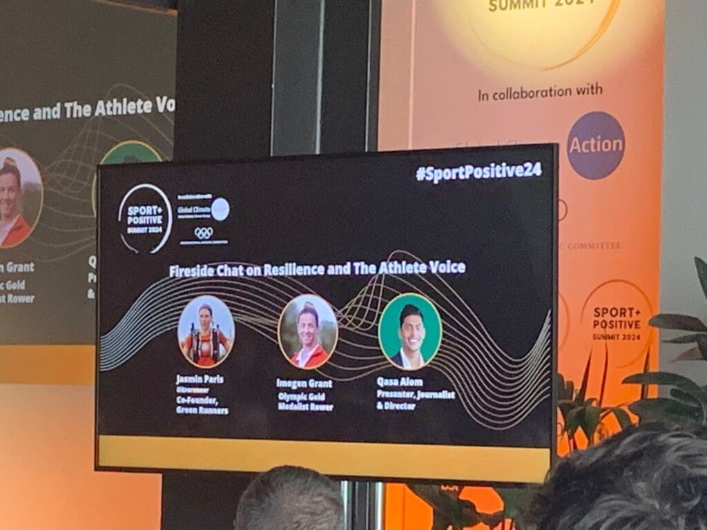 Stage screen showing panel name and headshots of speakers