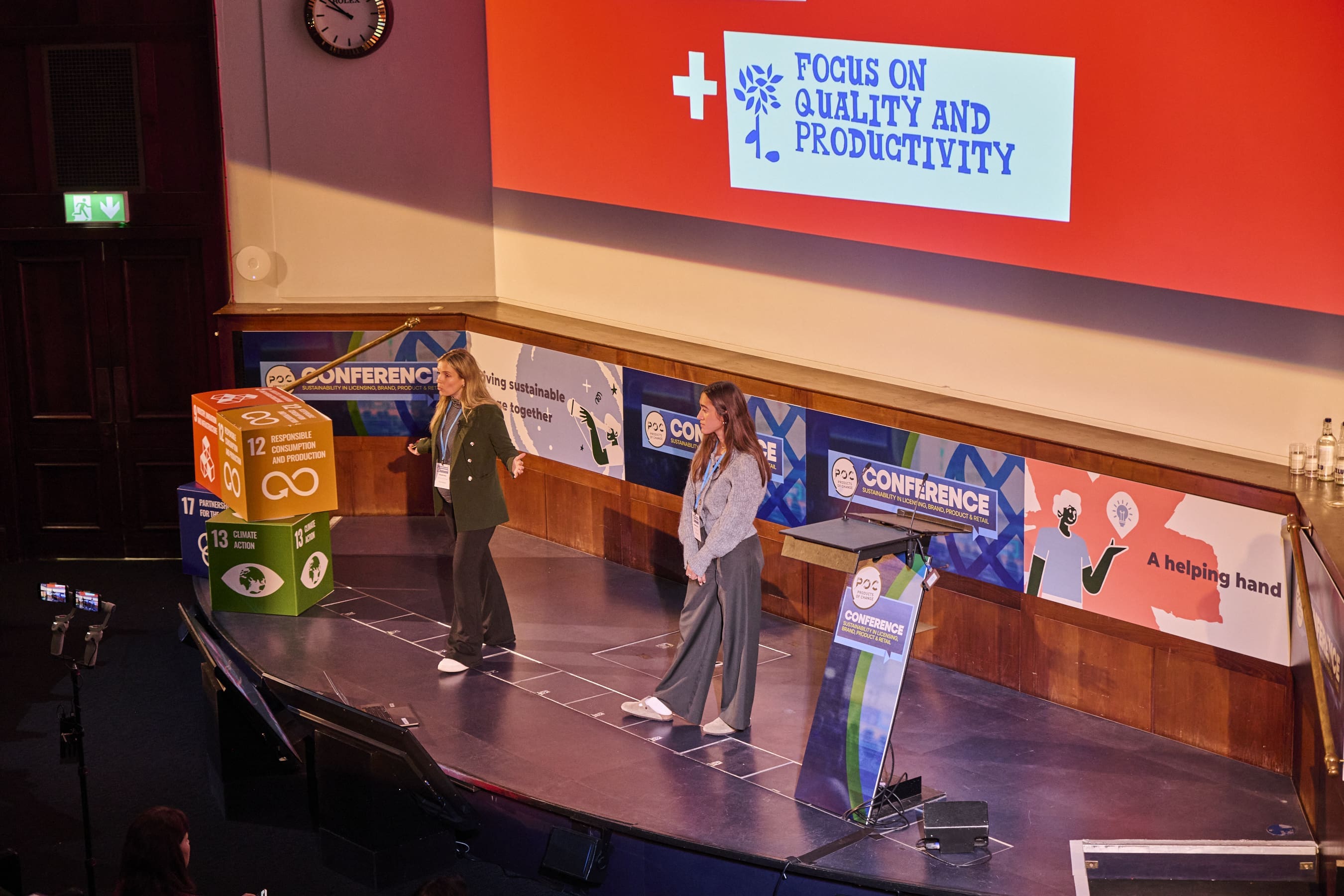 Two people on stage at a conference