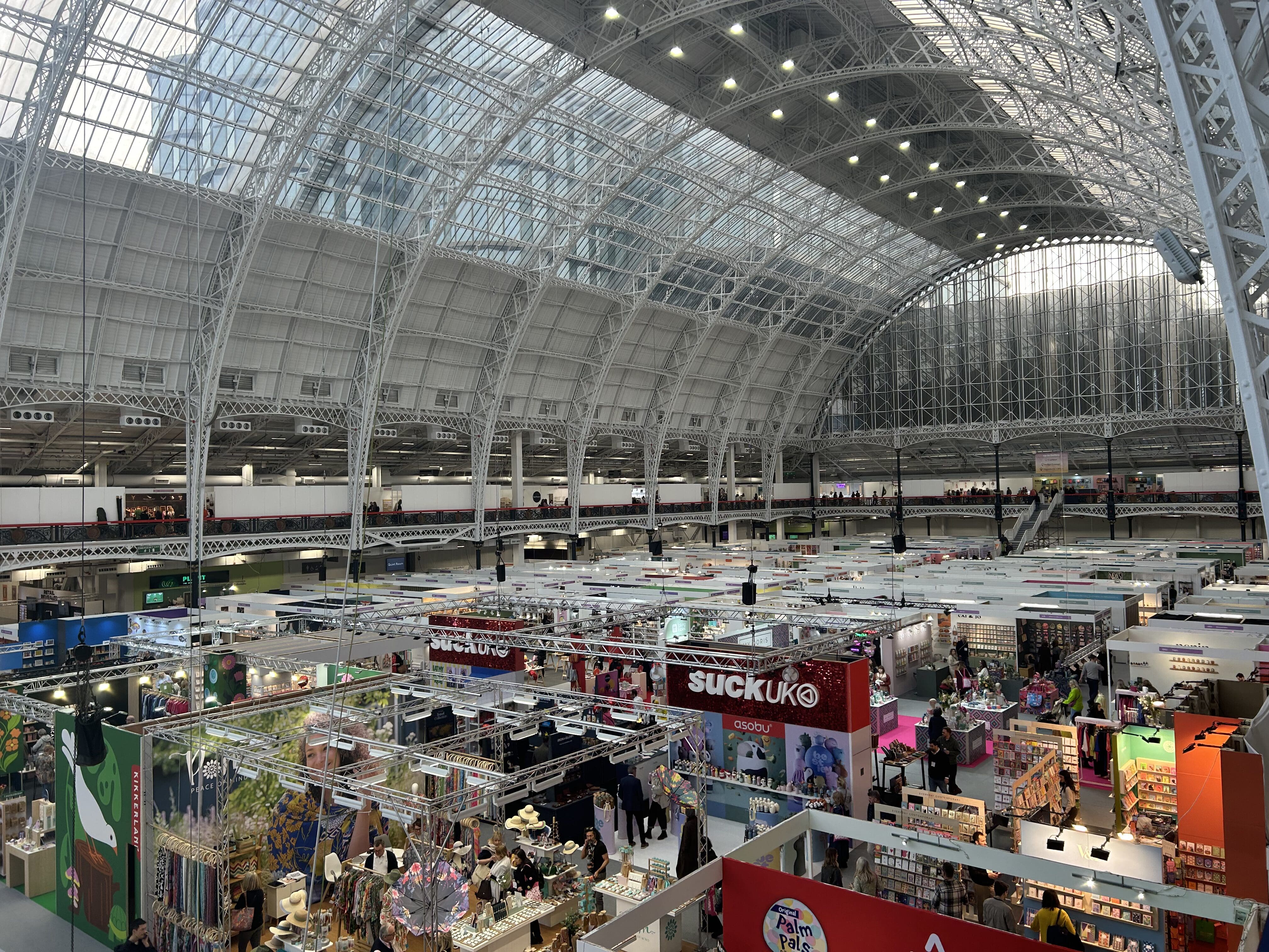 A view from above of the show floor under the arching glass ceiling.