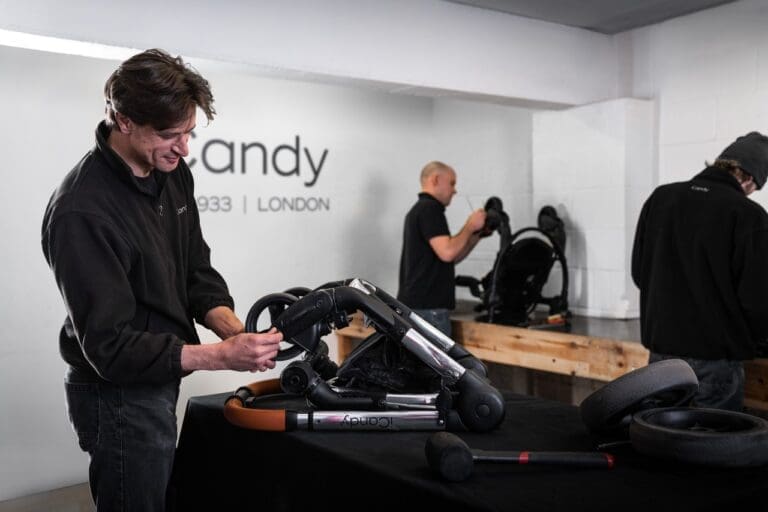 Two people repairing pushchairs